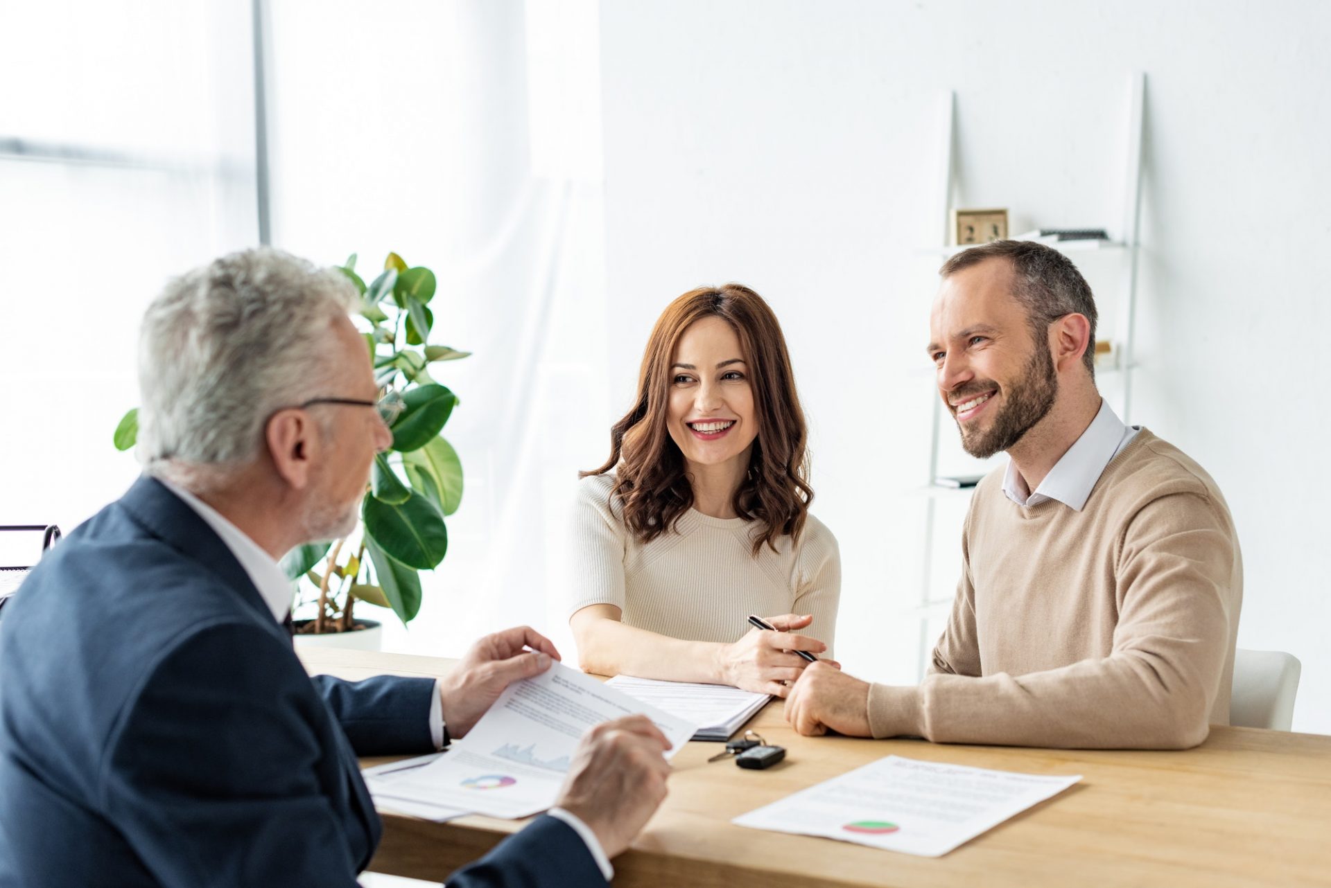 A couple choosing a new car with financing